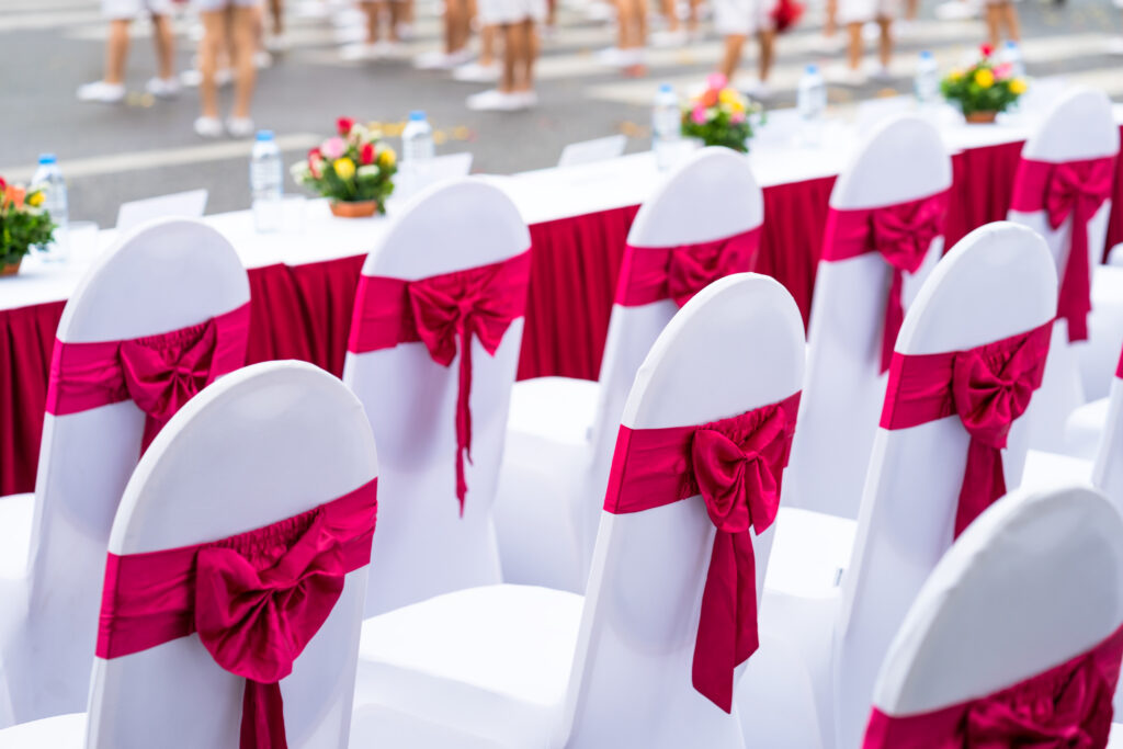 | Event chairs with white and red decoration lined up in row