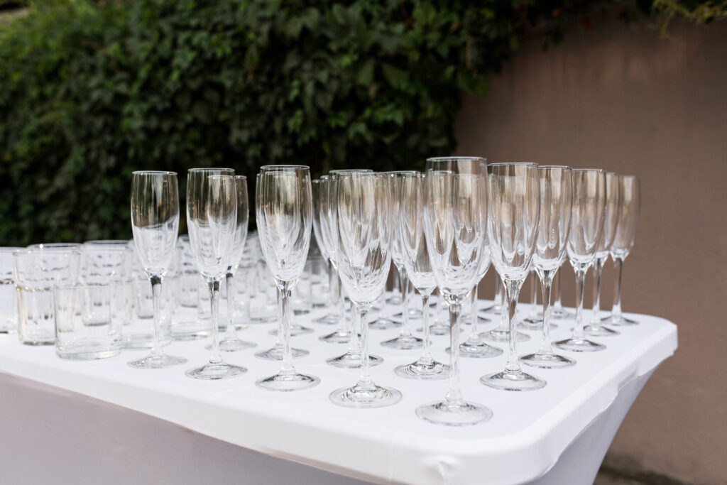 | Many empty clean glasses for guests at the buffet festive weddin