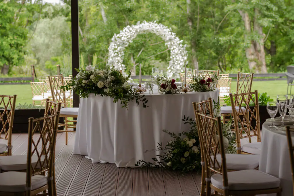 | Main table at a wedding reception with beautiful fresh flowers