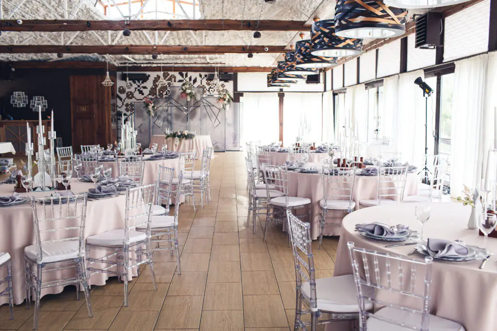 | A empty dining room decorated in red fabric.