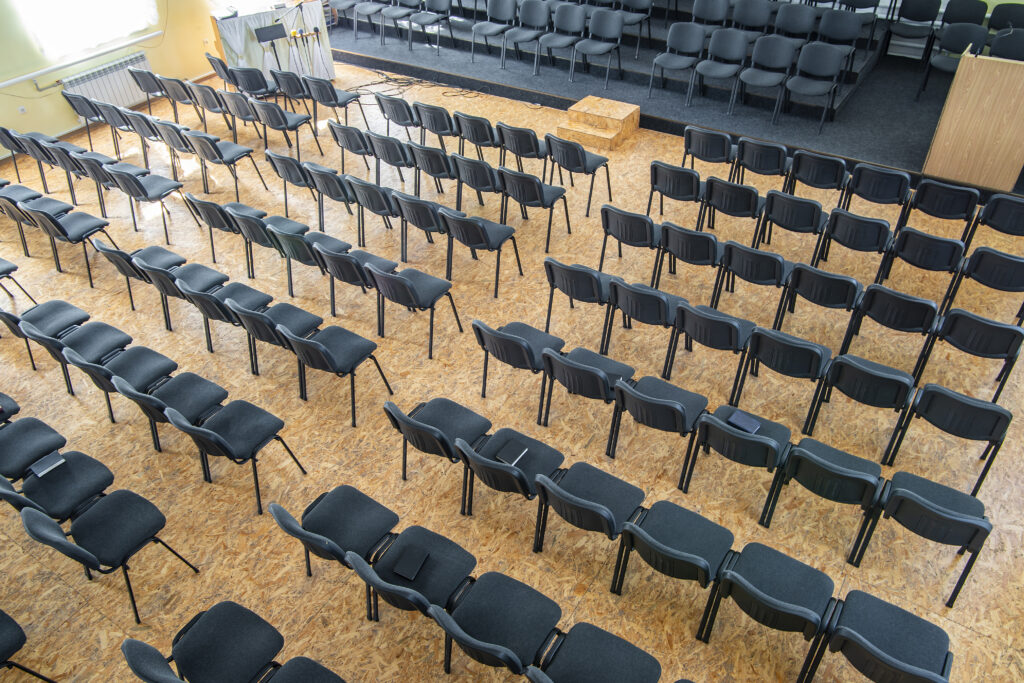 | Empty chairs in the assembly hall are arranged in rows, top view